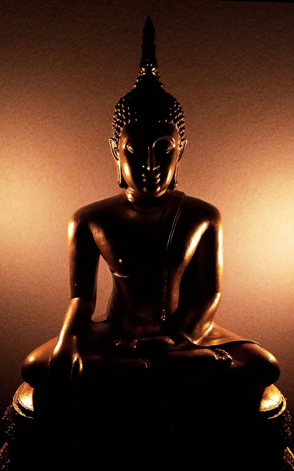 A Buddha image in candle light
